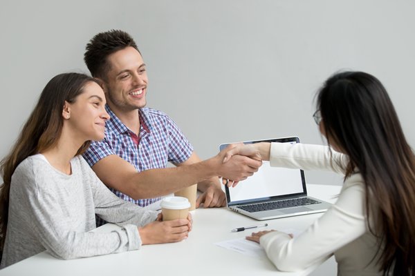 Smiling couple getting help from financial advisor